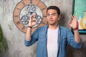 young-man-showing-ok-gesture-posing-marble-background-high-quality-photo-300x200